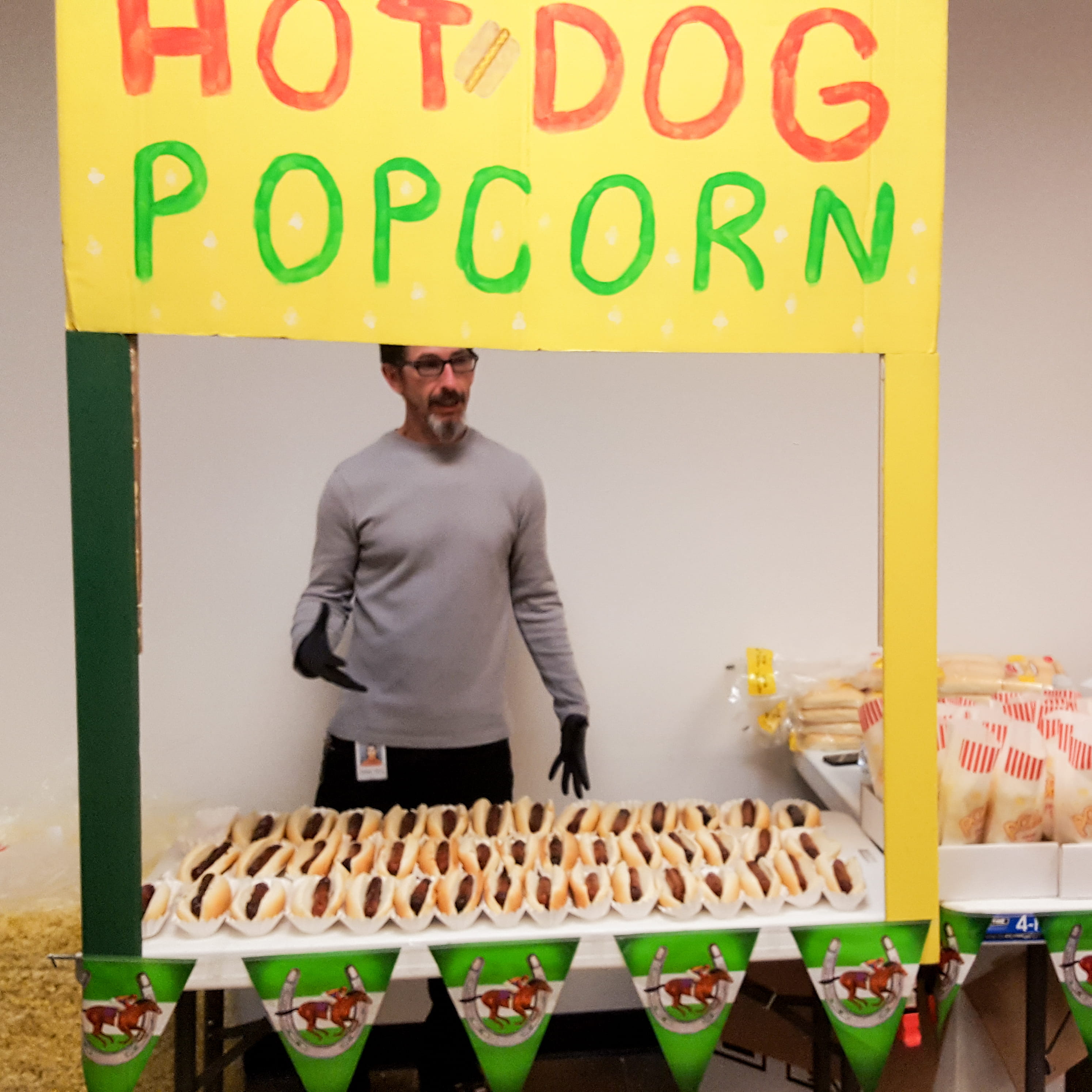Associate mans a hotdog and popcorn booth